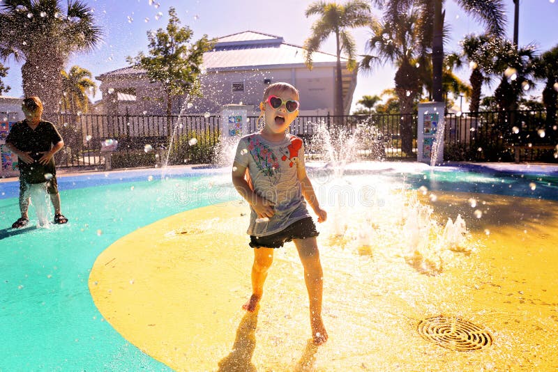 Little Child Playing in Water at Splash Park on Summer Day royalty free stock photography Little Child Playing in Water at Splash Park on Summer Day royalty free stock photography