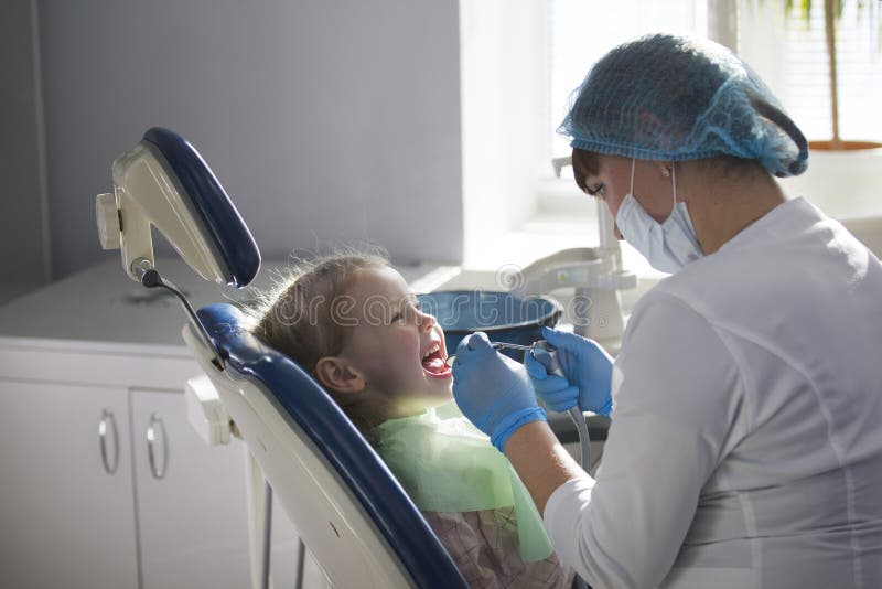Little child in stomatology chair - children dentistry stock photos Little child in stomatology chair - children dentistry stock photos