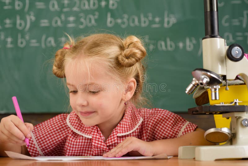 Little Child Study in Science Classroom. Elementary School Girl Work on
