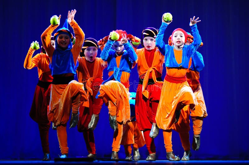 Little children dancing with old oriental costumes on stage