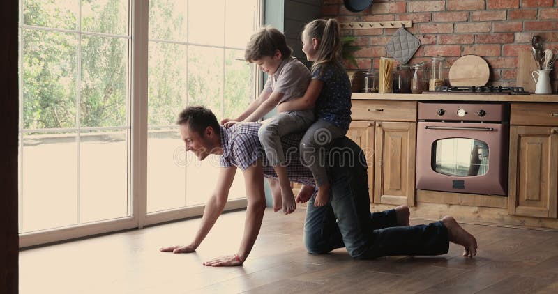 Free Photo  Mother and father playing with son or daughter in rocking  chair on light room floor with kitchen set on background, happy family  spending time together, playing with baby.