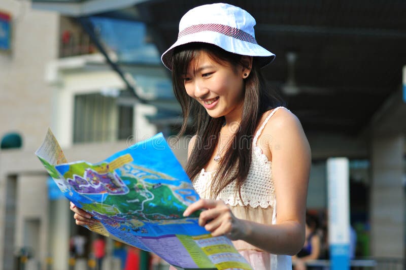 Little Chinese Asian Tourist Girl using her map 2