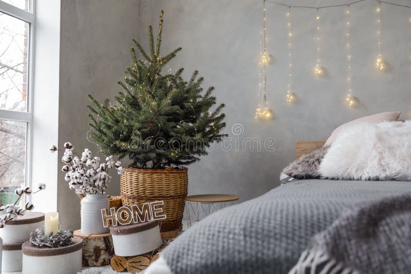 Little Christmas tree with fairy lights in interior royalty free stock images