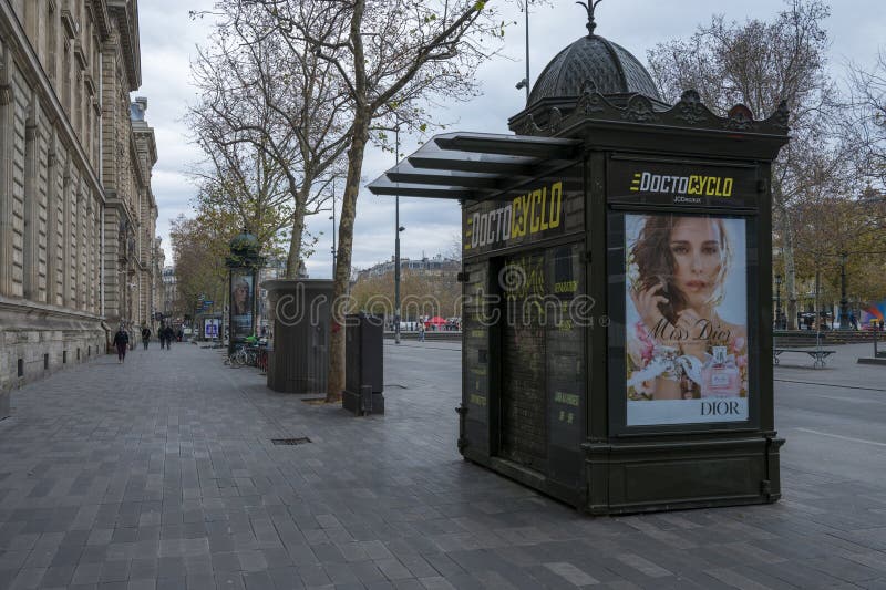 Little closed Parisian kiosque with Dior advertisement stock photography