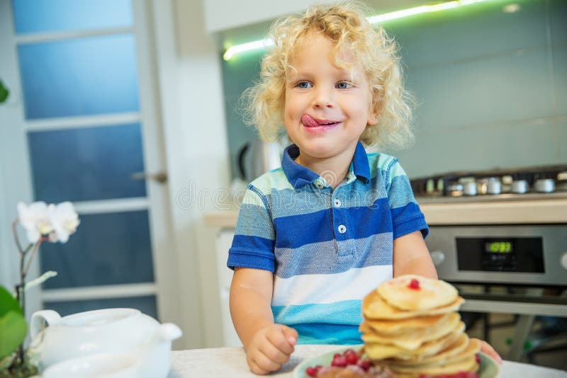 Little Curly Boy Eating Sweet Pancakes Stock Image - Image of morning ...