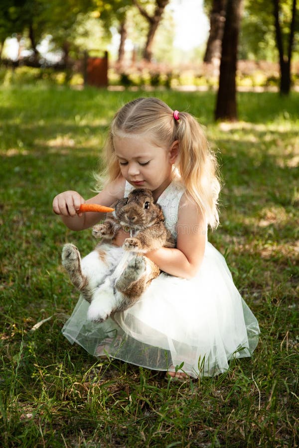 Little Cute Baby Girl Feeds Carrots Fluffy Pet Rabbit, Care and Living with Animal. Happy Childhood, Love of Nature Stock Image - Image of childhood, grass: 169847765 Little Cute Baby Girl Feeds Carrots Fluffy Pet Rabbit, Care and Living with Animal. Happy Childhood, Love of Nature Stock Image - Image of childhood, grass: 169847765