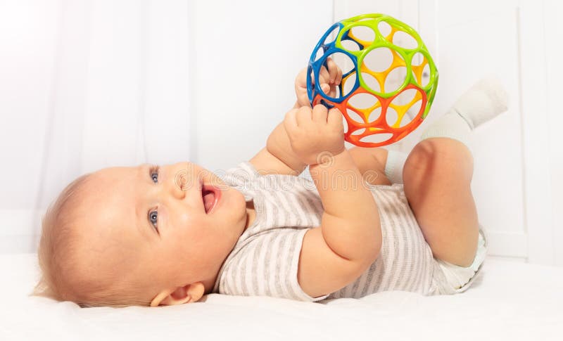 Little cute baby toddler play and hold toy ball