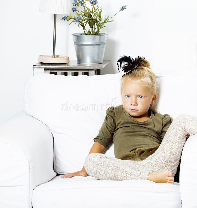 Little cute blond girl at home interior happy smiling close up, lifestyle people concept royalty free stock images Little cute blond girl at home interior happy smiling close up, lifestyle people concept royalty free stock images