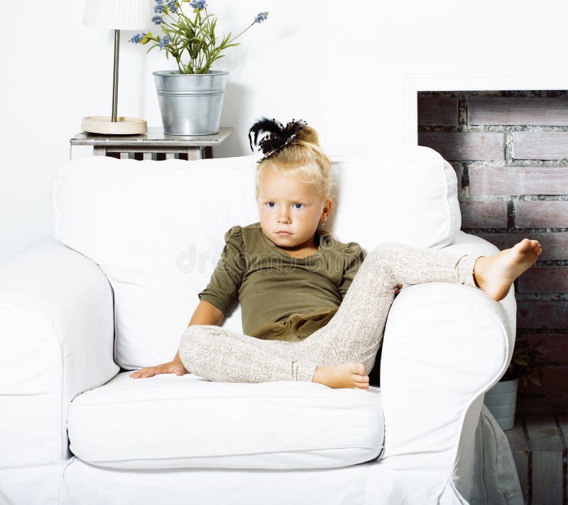 Little cute blond girl at home interior happy smiling close up, lifestyle people concept royalty free stock photography Little cute blond girl at home interior happy smiling close up, lifestyle people concept royalty free stock photography