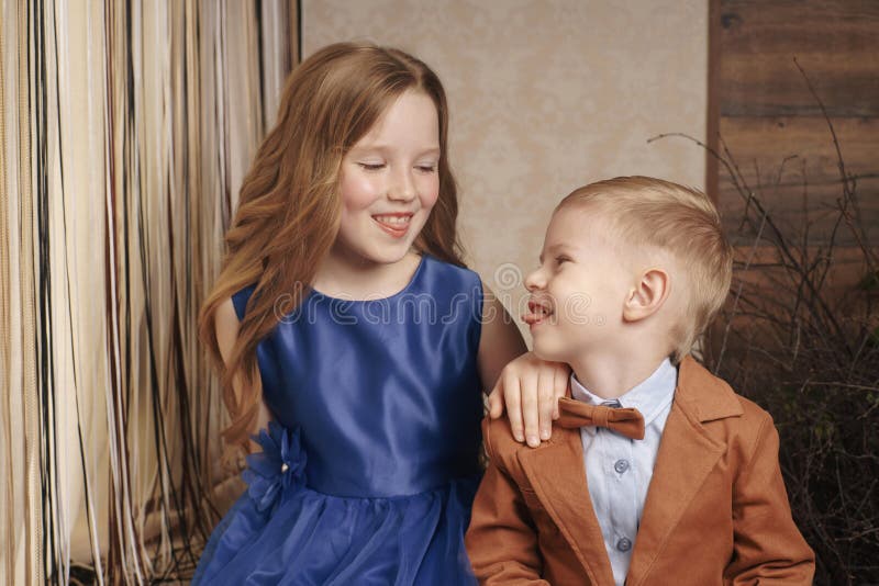 Little cute boy girl hugging playing on white background, happy family close up isolated. brother and sister smiling stock photo Little cute boy girl hugging playing on white background, happy family close up isolated. brother and sister smiling stock photo