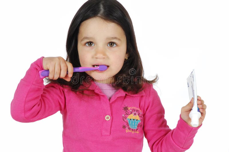 Little cute girl brushing the teeth
