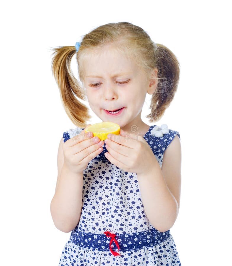 Little cute girl eating fresh lemon