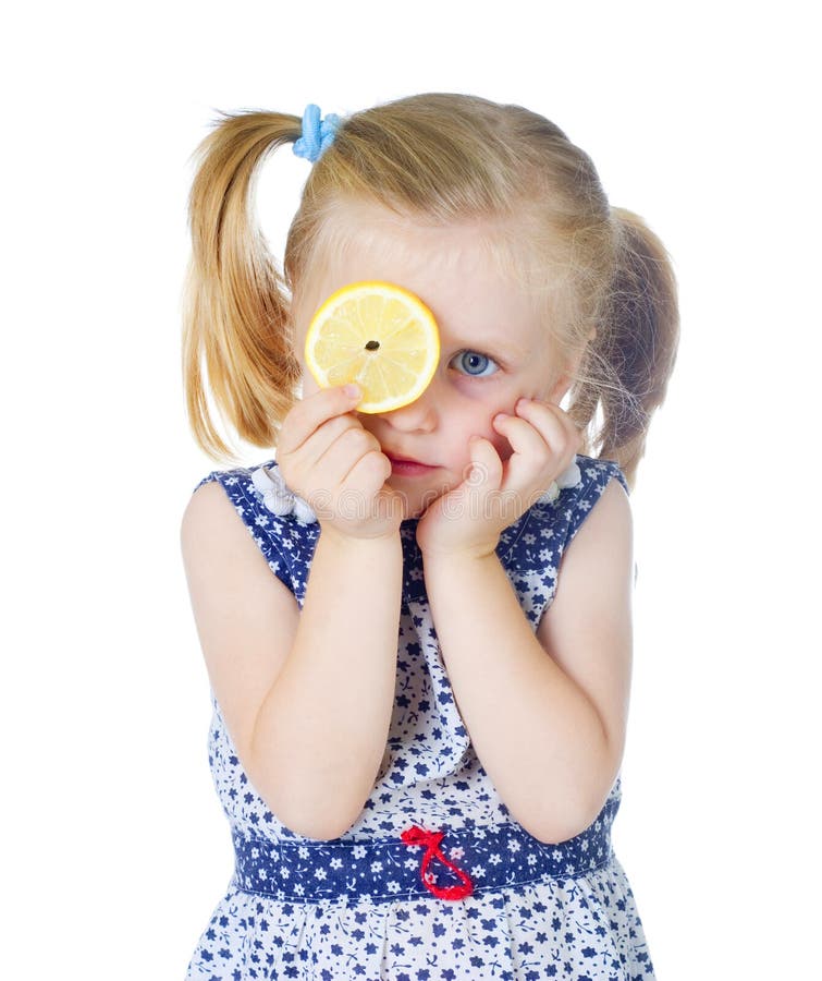 Little cute girl holding fresh lemon