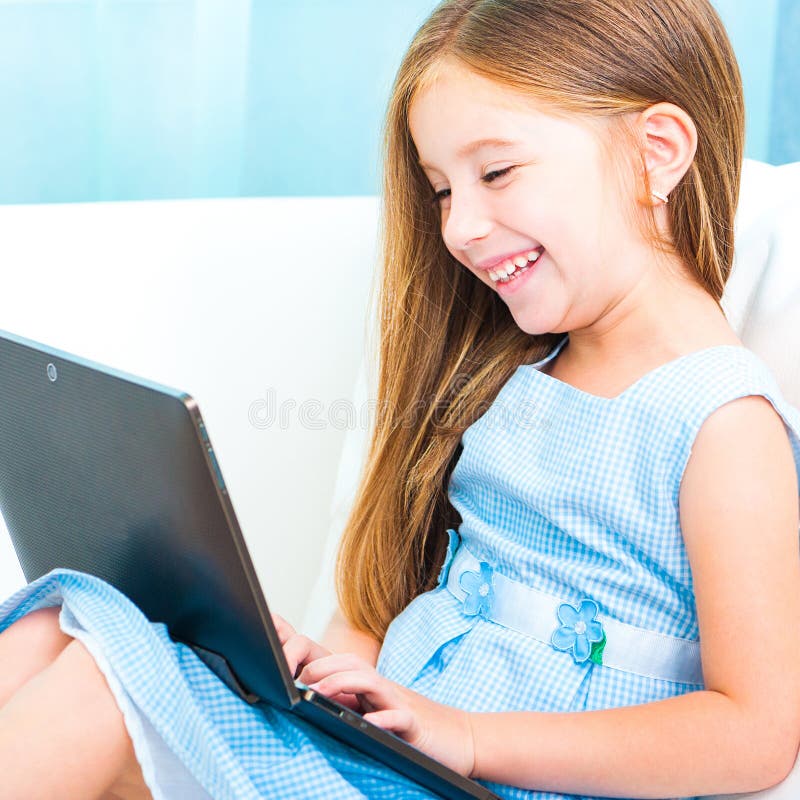 Little cute girl with a laptop