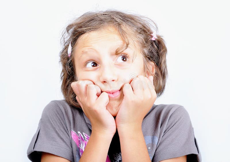 A little cute girl with strange expression on face