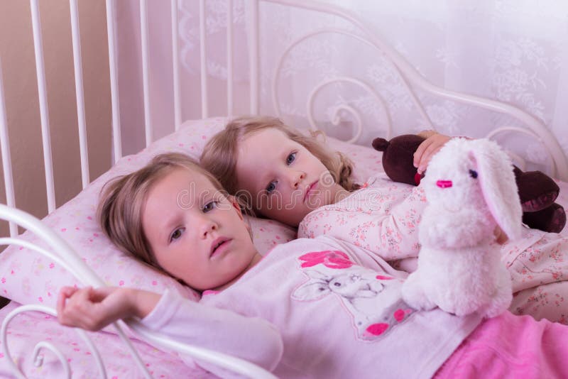 Little Cute Girls (sisters) Play In Bed. Stock Photo Image 60183534