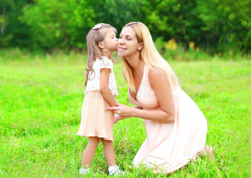 Little Daughter Child Kissing Loving Mother In Summer Day Happy Famil