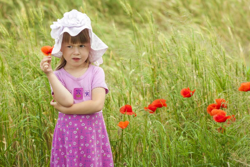 Little displeased and dissatisfied cute girl with red flower stock images Little displeased and dissatisfied cute girl with red flower stock images