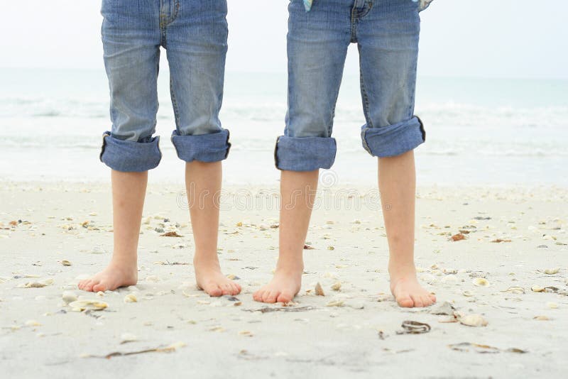 Little feet in the sand at the beach