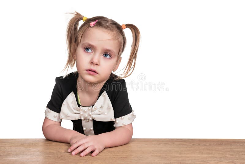 Little frustrated girl at the table