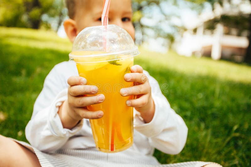 Little funny boy drinking a fresh lemonade stock images.