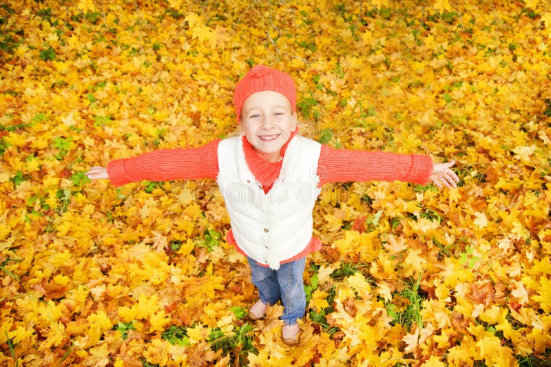 Little girl with autumn leaves