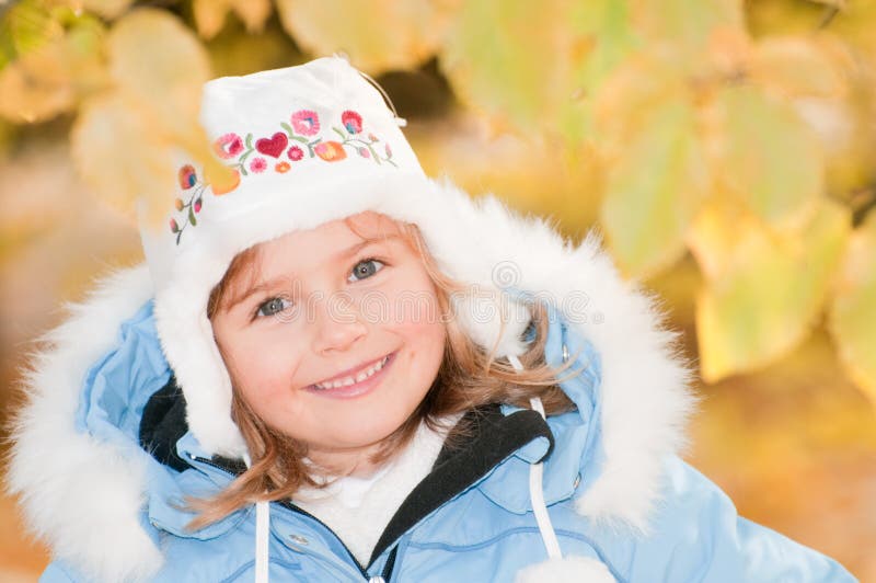 Little girl in autumn park