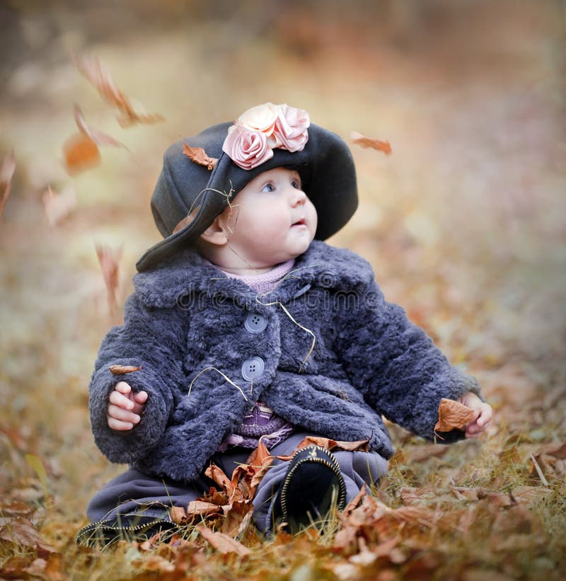 Little girl in autumn park