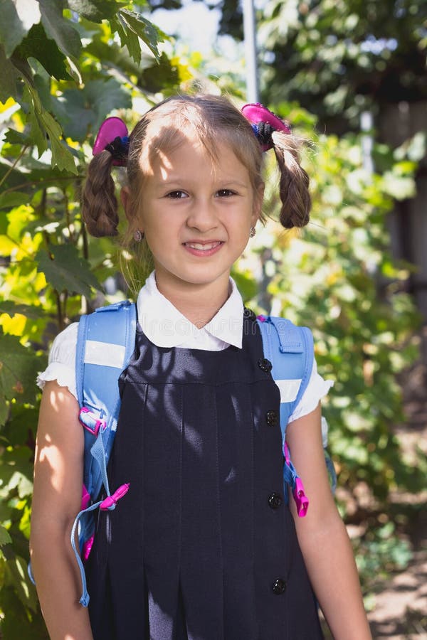 Little Girl with Backpack in the Vineyard in the Summer Stock Photo