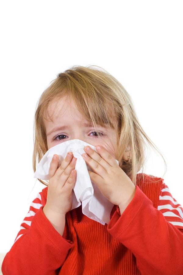 Little girl with the flu blowing her nose - isolated. Little girl with the flu blowing her nose - isolated