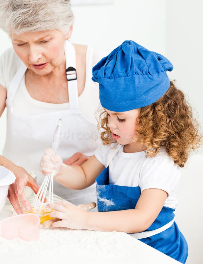 A Little Girl Baking with Her Grandmother Stock Photo Image of