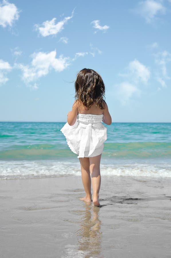 Adorable Happy Little Girl Lies On The Sea Beach And 