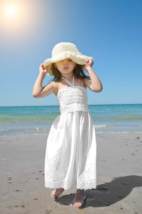 Adorable Little Girl in a Straw Hat on the Beach during Summer Stock ...