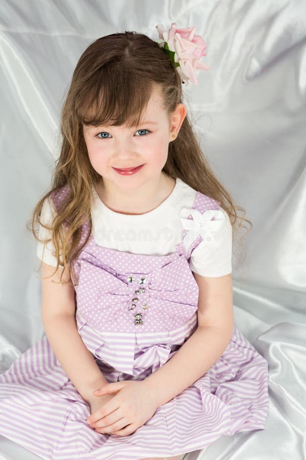 Little girl in a beautiful dress with flower