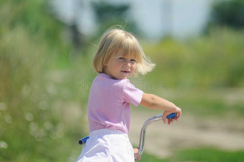 The little girl on a bicycle