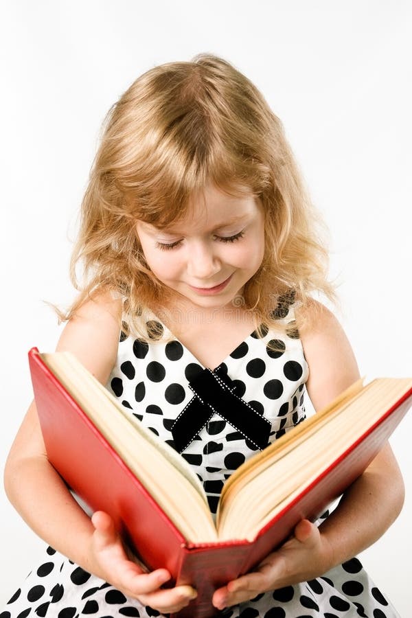 Little girl with a big book isolated on white