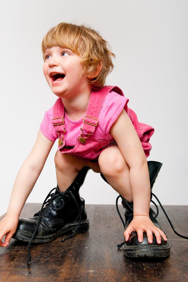 Little girl in big boots stock photo. Image of table 52500852