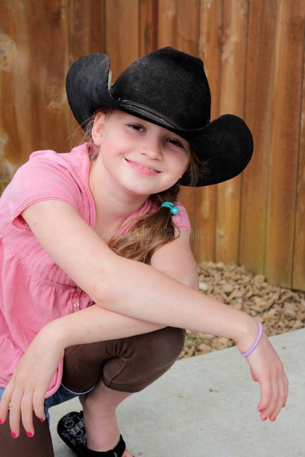 Little girl in black western hat stock photo Little girl in black western hat stock photo