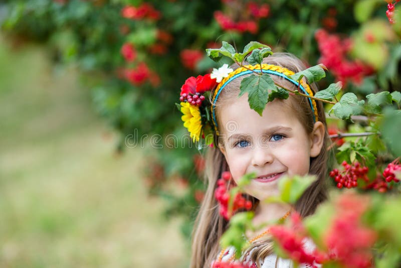 A Little Girl with Blond Hair in a Ukrainian Folk Costume Stands Near ...