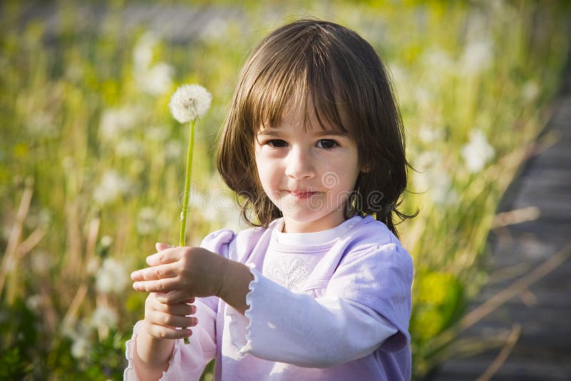 Little girl and blow ball