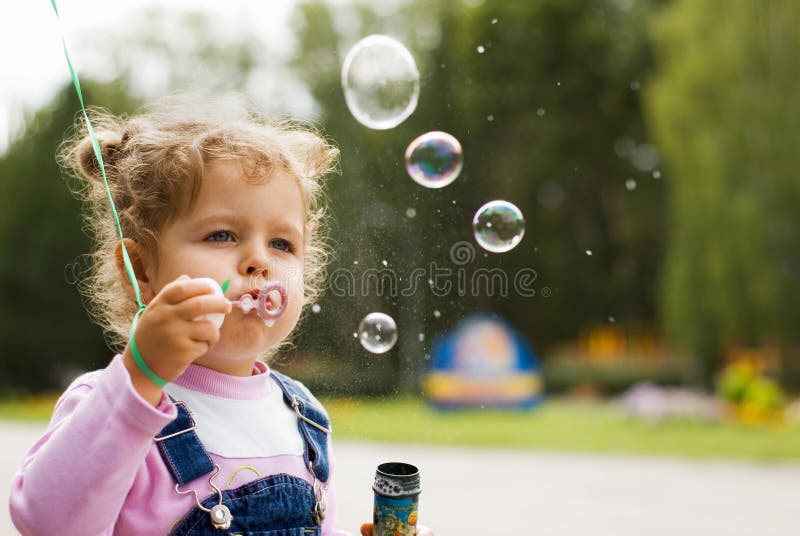 Little girl blow bubbles