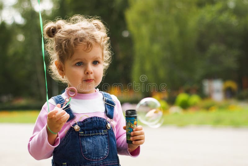 Little girl blow bubbles