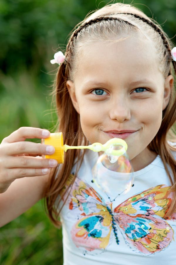 Little Girl Blowing Bubbles Stock Photo - Image of playful, shiny: 15849280