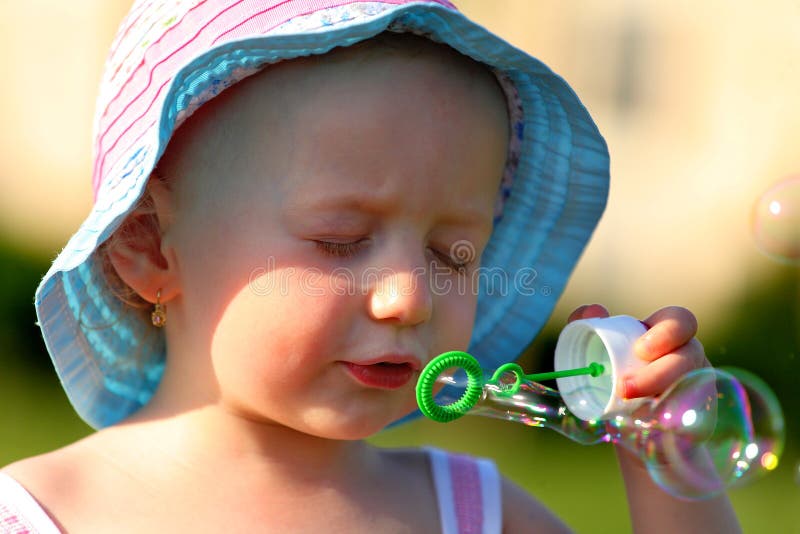 Little girl blowing soap bubbles royalty free stock photography Little girl blowing soap bubbles royalty free stock photography