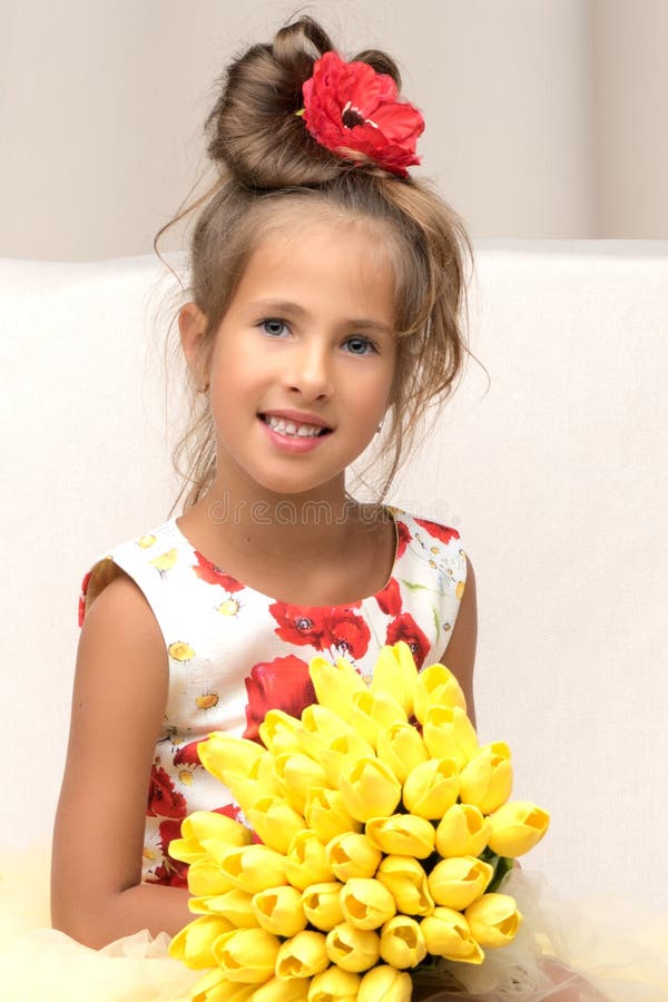 Little girl with a bouquet of flowers stock image Little girl with a bouquet of flowers stock image