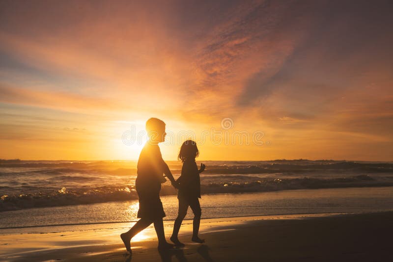 Little girl and boy playing on beach