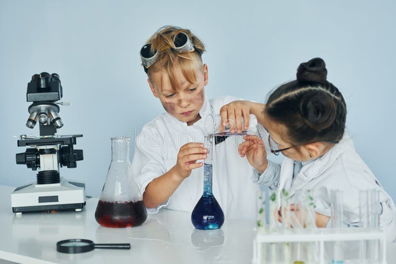 Little Girl and Boy in White Coats Plays a Scientists in Lab by Using ...