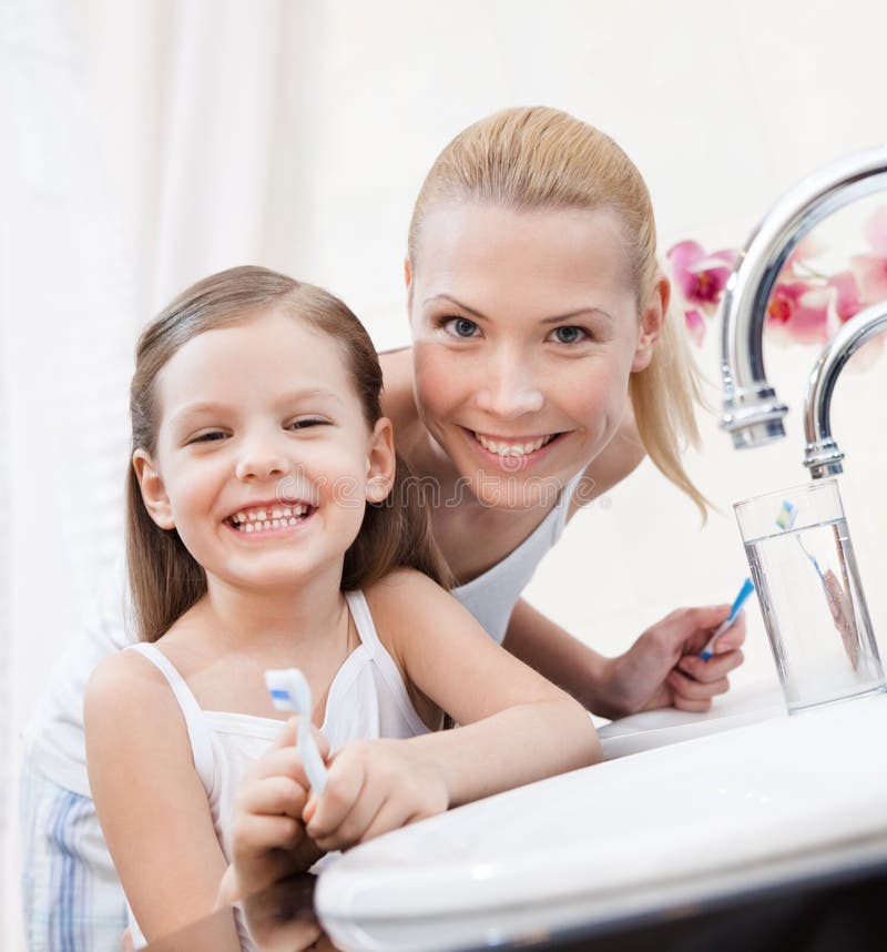 Little Girl Brushes Teeth with Her Mom Stock Photo Image of bathroom
