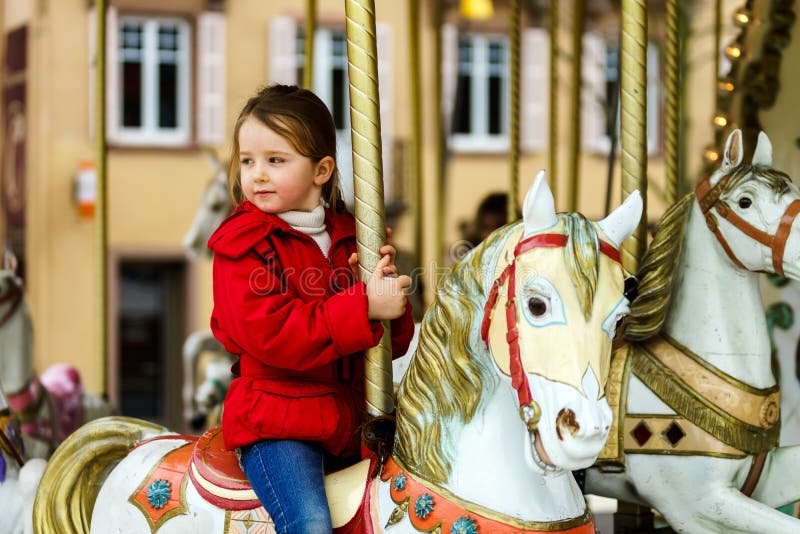 Little girl on carousel horse