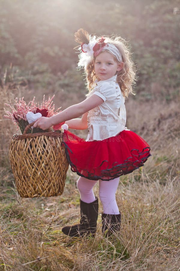 Little girl carrying wicker basket